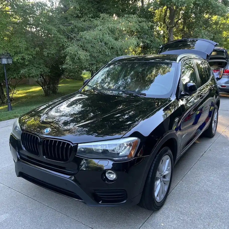 Black BMW detailed by Fly Auto Spa in Ottawa driveway